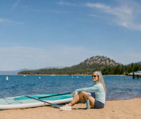 Woman with Paddleboard on Lake Tahoe Beach